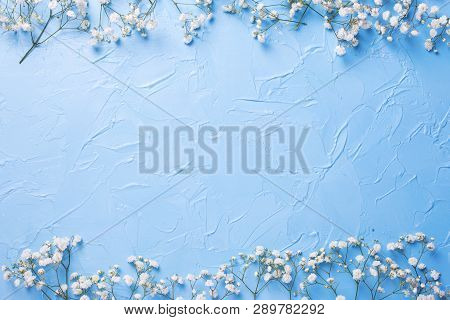 Border  From Fresh White Gypsofila  Flowers On Blue Textured Background. Top View. Flat Lay. Place F