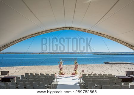 Event Decoration. Wedding Chuppa At Riverside Decorated With Fresh Flowers. Florist Workflow.