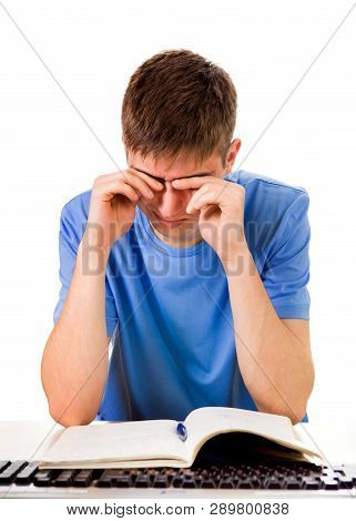 Tired Student Rub An Eyes On The School Desk Isolated On The White Background