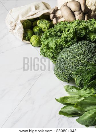 Healthy Green Vegan Ingredients For Cooking. Various Clean Green Vegetables And Herbs On Marble Back