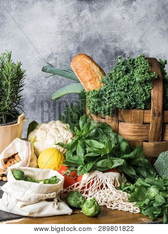 Healthy Vegetarian Ingredients For Cooking. Various Clean Vegetables, Herbs, Nut And Bread On Table.
