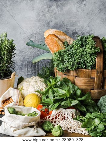 Healthy Vegetarian Ingredients For Cooking. Various Clean Vegetables, Herbs, Nut And Bread On Table.