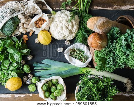 Healthy Vegetarian Ingredients For Cooking. Various Clean Vegetables, Herbs, Nut And Bread On Black 