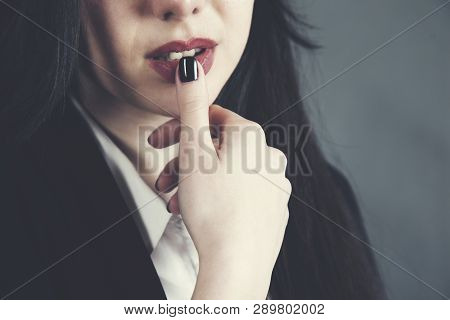 Woman Finger In Lip In Dark Background
