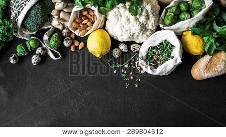 Healthy Vegetarian Ingredients For Cooking. Various Clean Vegetables, Herbs, Nut And Bread On Black 