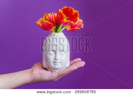 Buddha Head With Gred Tulips In Man's Hand  Buds  On A Vibrant Violet Background, Yoga Zen Meditatio