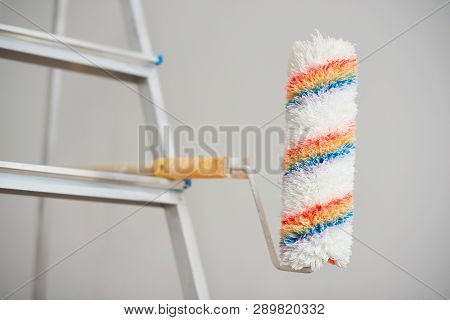 Roller Painter On Step Ledder. House Renovation Concept