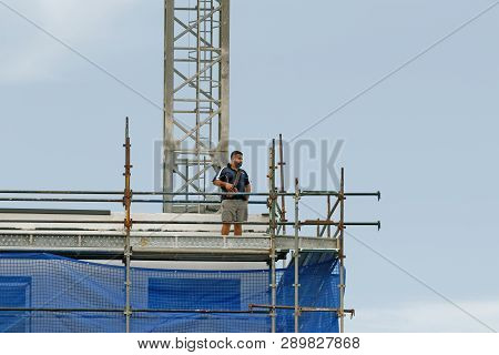Gosford, New South Wales, Australia - January 31, 2019: Crane Operator Remotely Controlling A Workin