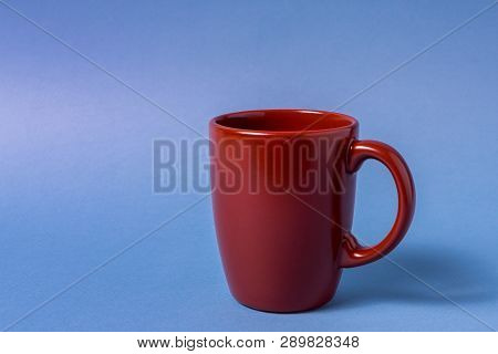 Big Brown Empty Mug Isolated On Blue Background, Horizontal Orientation.