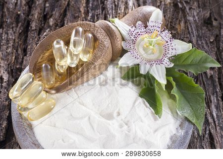 Hydrolyzed Collagen And Passion Flower On Wooden Background