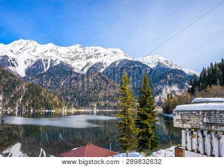 Mountains Covered With Snow On The Shore Of A Beautiful Lake