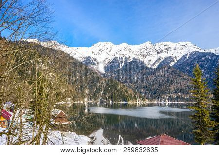 Mountains Covered With Snow On The Shore Of A Beautiful Lake