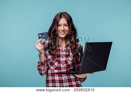 Picture Of Nice Young Woman Holding Black Laltop And Purple Credit Card.
