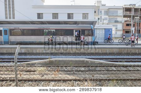 Vr Sto Antonio, Portugal - Sept 30th, 2017: Mountain Bikers Getting Down From Train At Railway Stati