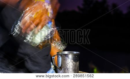 Time Of Pouring The Liquor Into The Water Cans Made Of Stainless Steel.