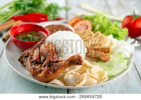 Nasi lemak kukus with fried drumstick, popular traditional Malaysian local food.
