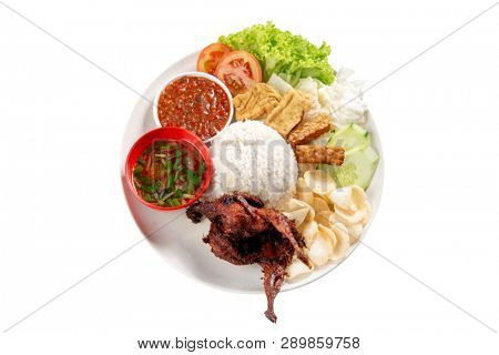 Nasi lemak kukus with quail meat, popular traditional Malaysian local food. Isolated on white background. Flat lay top down overhead view.