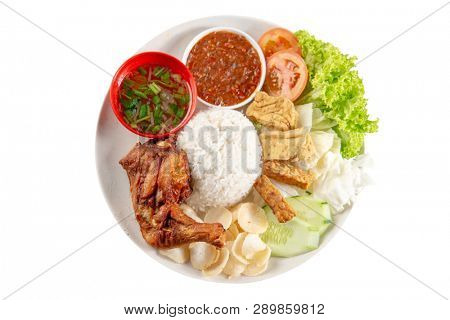 Nasi lemak kukus with fried drumstick, popular traditional Malaysian local food. Isolated on white background. Flat lay top down overhead view.
