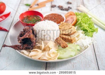 Nasi lemak kukus with quail meat, popular traditional Malaysian local food.