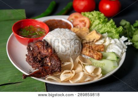 Nasi lemak kukus with quail meat, popular traditional Malaysian local food.