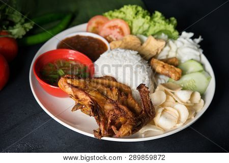 Nasi lemak kukus with fried chicken, popular traditional Malaysian local food.