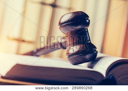 Court hammer laying on book. Justice, trial and law symbol. Judgment.