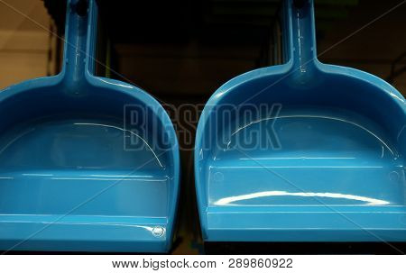 Plastic household  scoops in store, close up