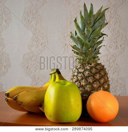Still Life With Fresh Fruits Apple, Banana, Pineapple And Orange On Table Colorful