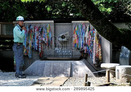 Ueno Park, Tokyo, Japan - July 9, 2018 : A Worker Standing Beside The Cnd Peace Monument In Ueno Par