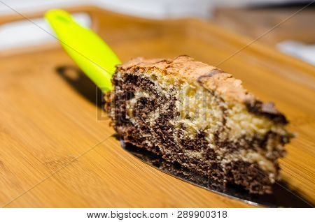 Delicious Homemade Chocolate Cake With Cottage Cheese On The Wooden Table Background. A Piece Is Cut