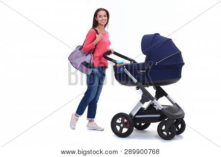 Full length portrait of a mother with a stroller, isolated on white background. Young mom