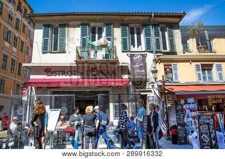 Nice, France - April 18 2017. French Bistro And Souvenir Shops, French Riviera. A Lot Of Tourists In