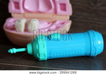 Teeth Model With Dental Tools, Toys On Wooden Background