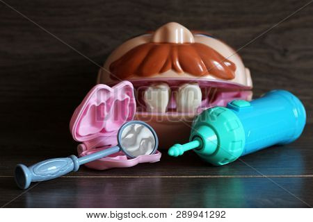 Teeth Model With Dental Tools, Toys On Wooden Background