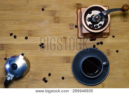 A Cup Of Espresso Coffee, Put On A Wooden Table, An Italian Coffee Maker (moka) And In The Backgroun