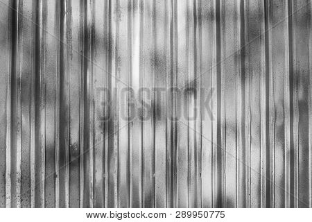 Wall Made Of Gray Metal Sheet. Zinc-like Used As A Fence To Divide Construction. Modern Style Backgr