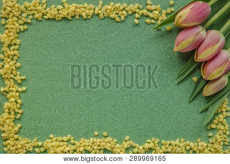 Red Tulips With Yellow Drops On Green Glitter Background With Copy Space