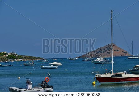 Blue Sea With Many Small Boats On It