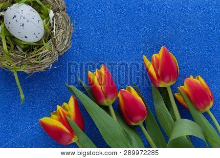 Easter Background With Red-yellow Tulips And Egg On Green Glitter Background With Copy Space