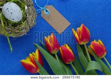 Easter Background With Red-yellow Tulips And Egg On Green Glitter Background With Copy Space