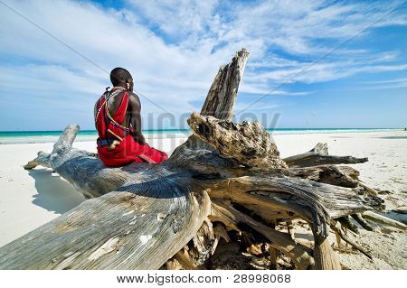 Maasai sitting by the ocean on the beach