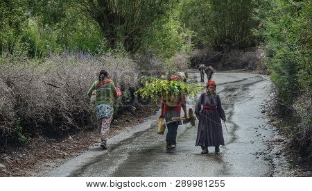 Tibetan People Walking On Rural Road