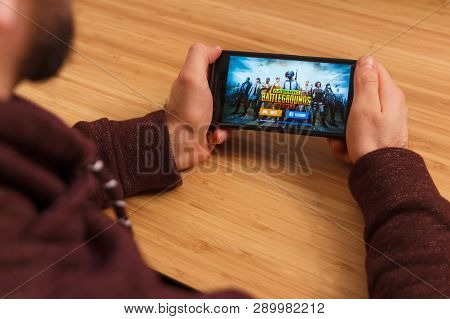 Prague, Czech Republic - March 16, 2019: Man Holding A Smartphone And Playng The Playerunknown S Bat