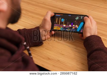 Prague, Czech Republic - March 16, 2019: Man Holding A Smartphone And Playng The Minecraft Mobile Ga