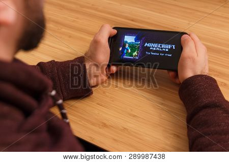 Prague, Czech Republic - March 16, 2019: Man Holding A Smartphone And Playng The Minecraft Mobile Ga