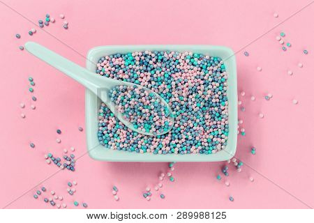 Colorful Nonpareils Cake Candy Sprinkles In White Rectangular Bowl And Spoon On Pink Background In F