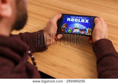 Prague, Czech Republic - March 16, 2019: Man Holding A Smartphone And Playng The Roblox Mobile Game.