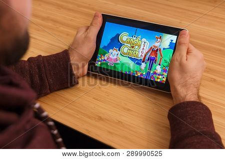 Prague, Czech Republic - March 16, 2019: Man Holding A Smartphone And Playng The Candy Crush Saga Mo