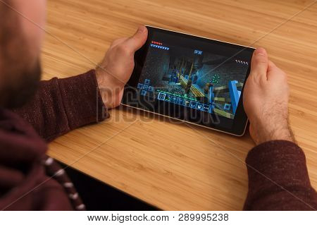 Prague, Czech Republic - March 16, 2019: Man Holding A Smartphone And Playng The Minecraft Mobile Ga
