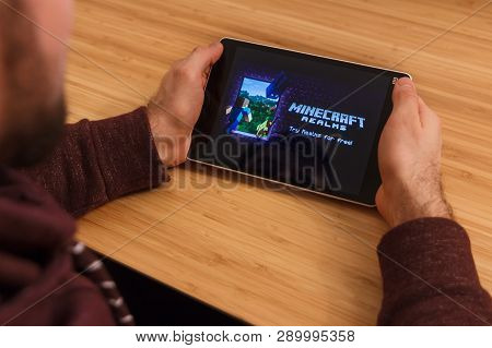 Prague, Czech Republic - March 16, 2019: Man Holding A Smartphone And Playng The Minecraft Mobile Ga